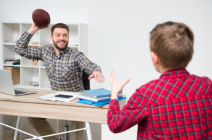 dad and son play football work from home