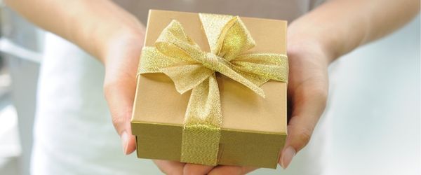 handing a goldwrapped gift